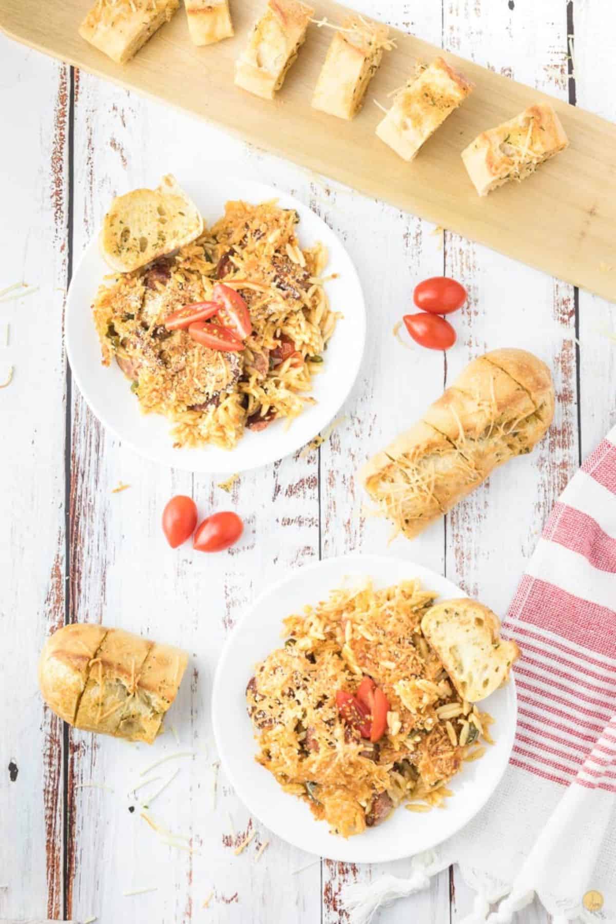 two plates of pasta skillet meal with garlic bread