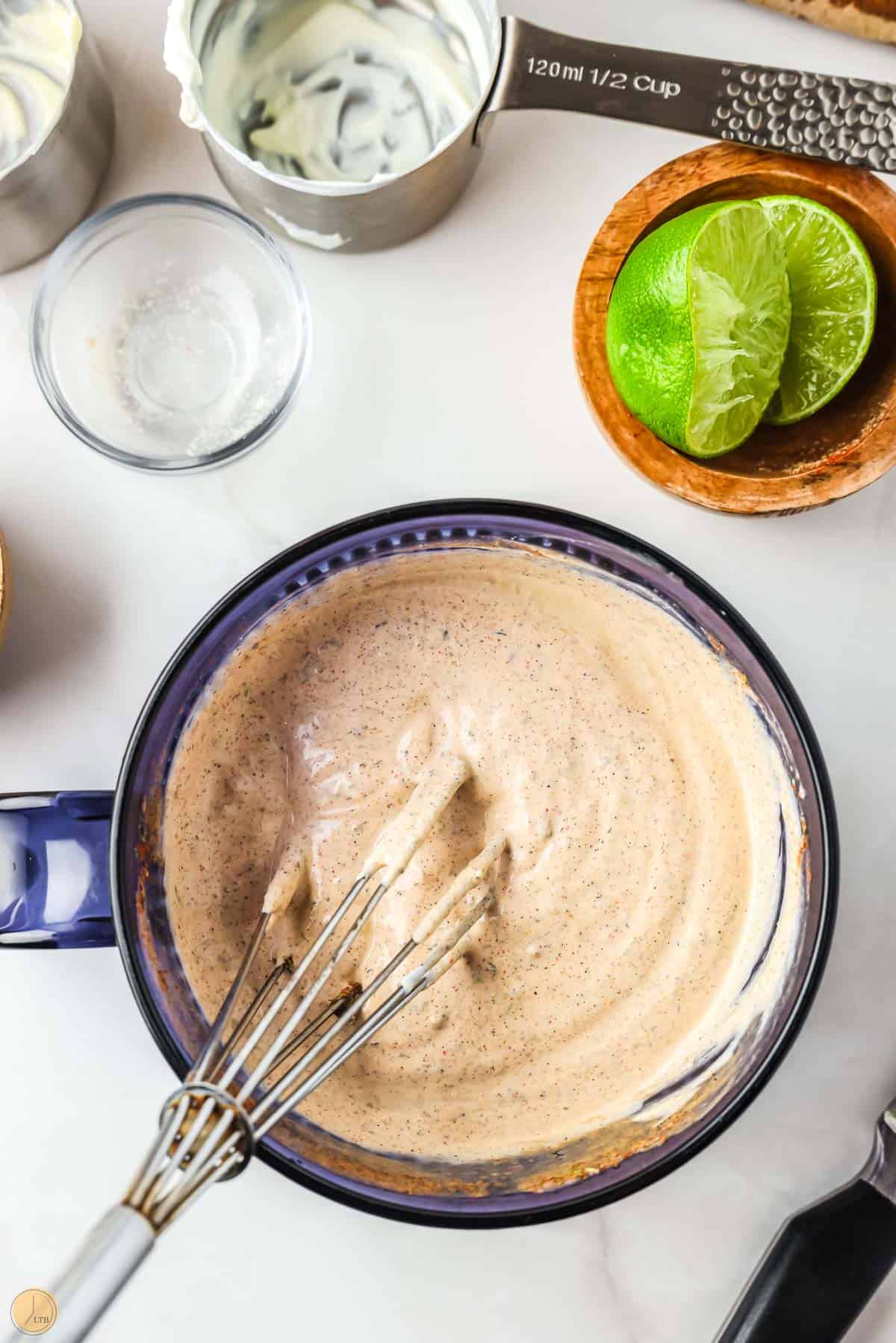 spicy ranch dressing in a bowl with a whisk