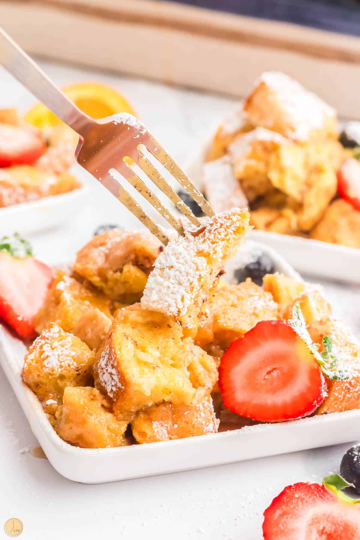 fork with bites of french toast on it