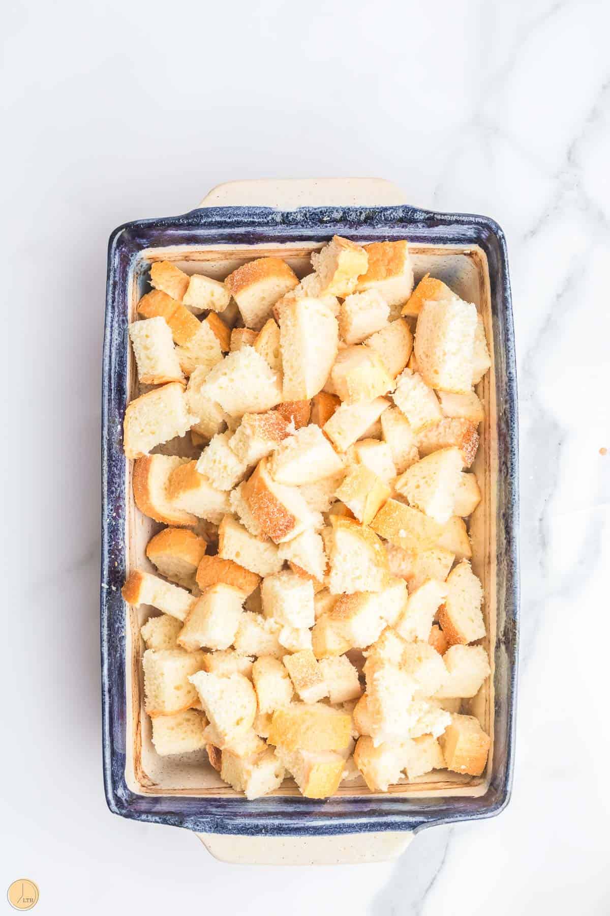 cubed bread in a casserole dish