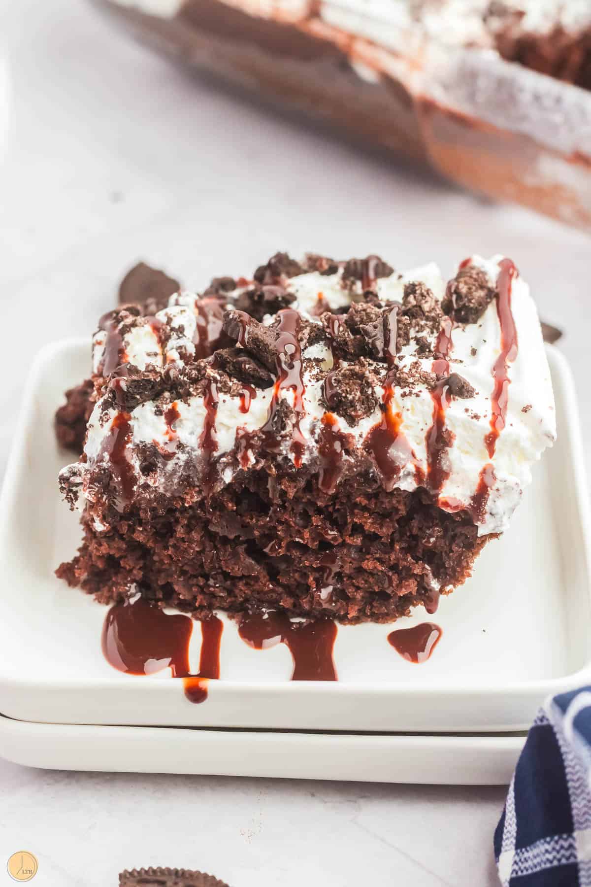 slice of chocolate cake on a stack of white plates
