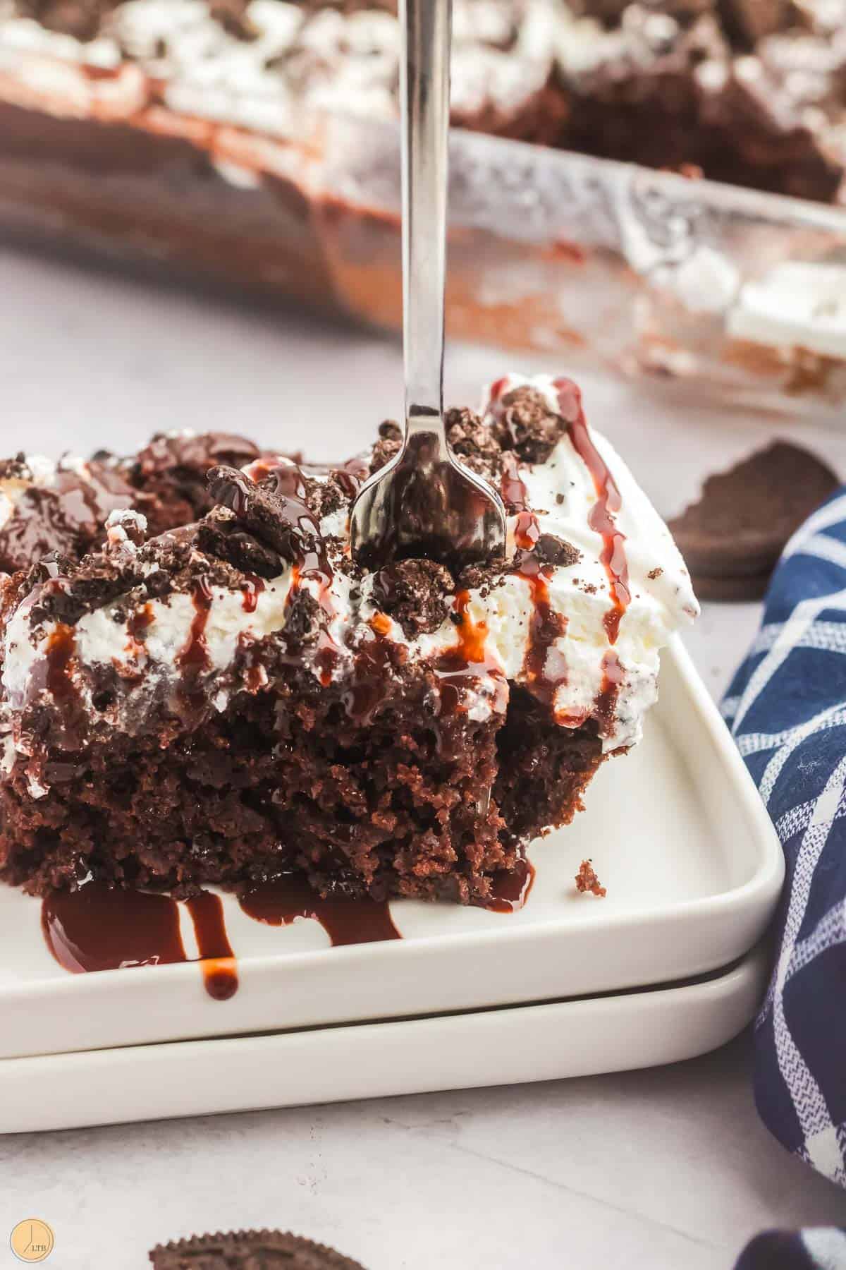 pieces of cake on a stack of white plates with a fork sticking in it