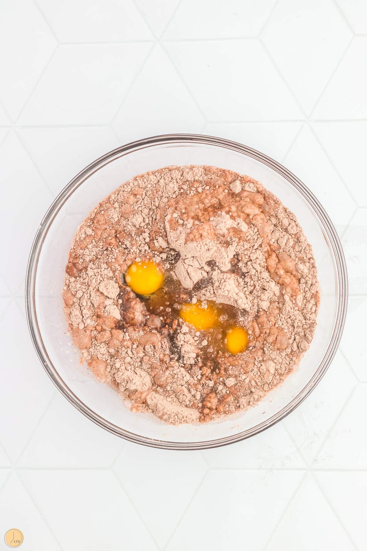 cake mix and eggs in a clear bowl
