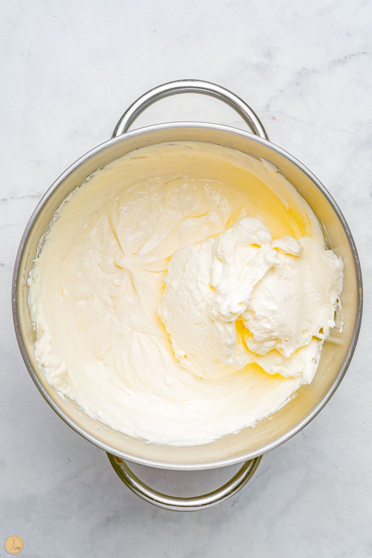 cream cheese mixture in a silver mixing bowl