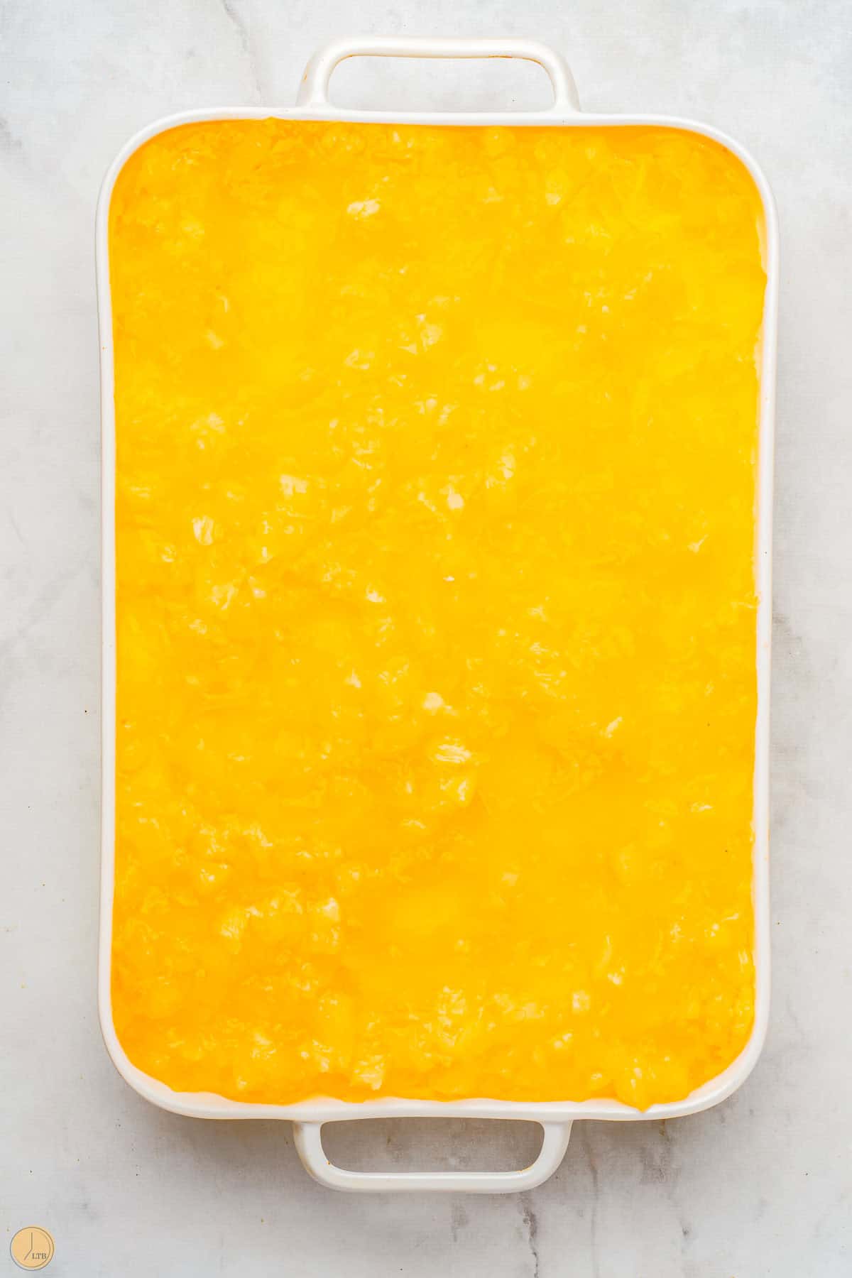 pineapple pretzel salad in a white casserole dish