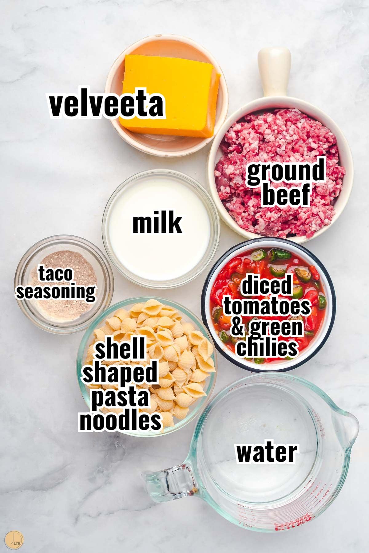 ingredients for skillet taco mac with velveeta with text overlay labeling them