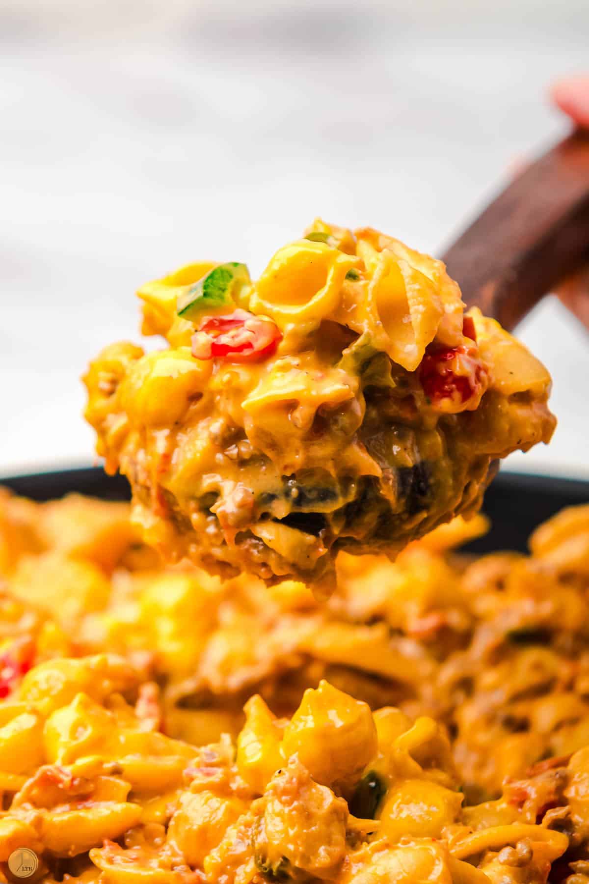 wood spoon with scoop of taco mac and cheese
