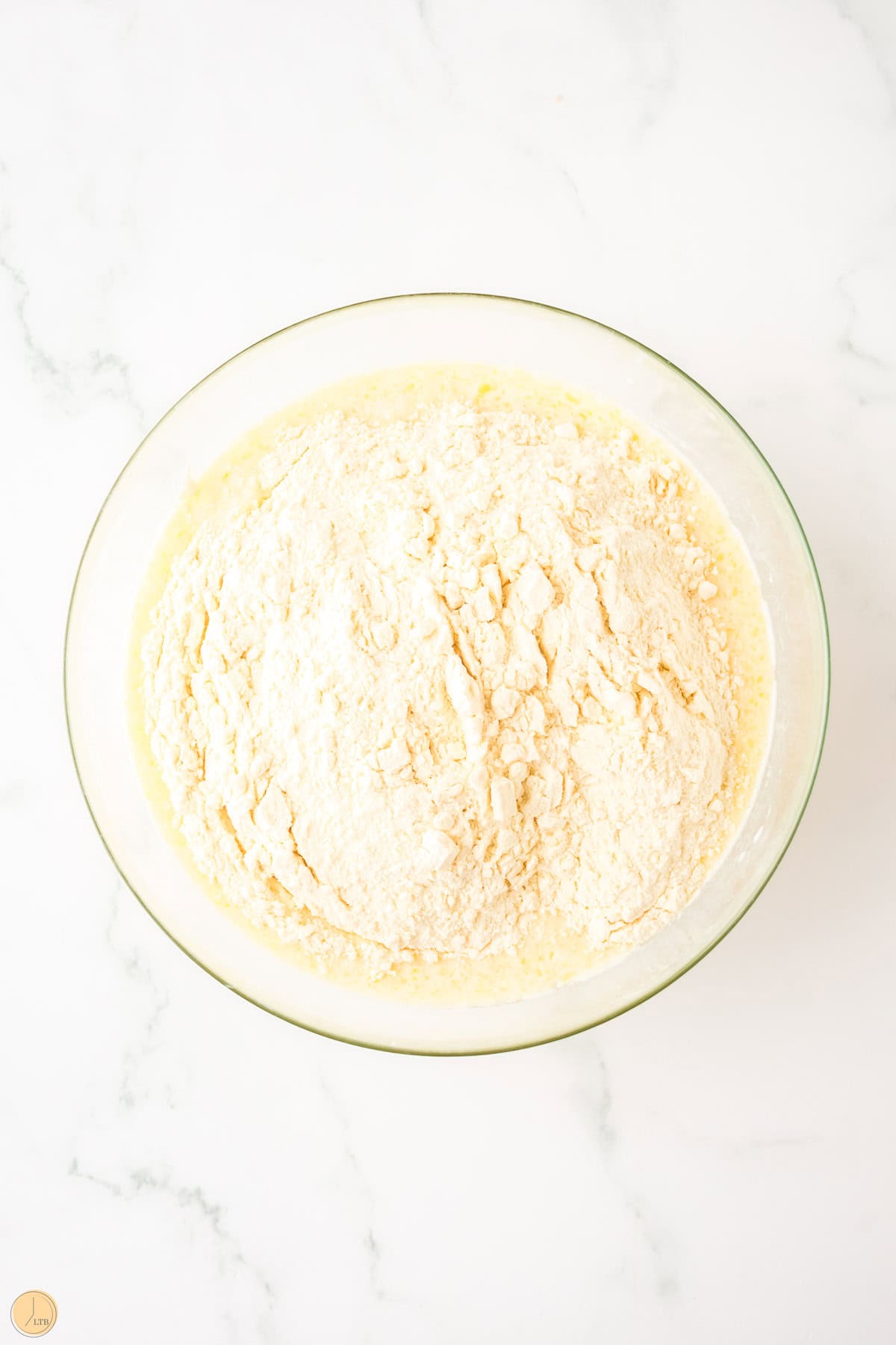 milk, butter, and flour in a clear bowl before it's mixed together